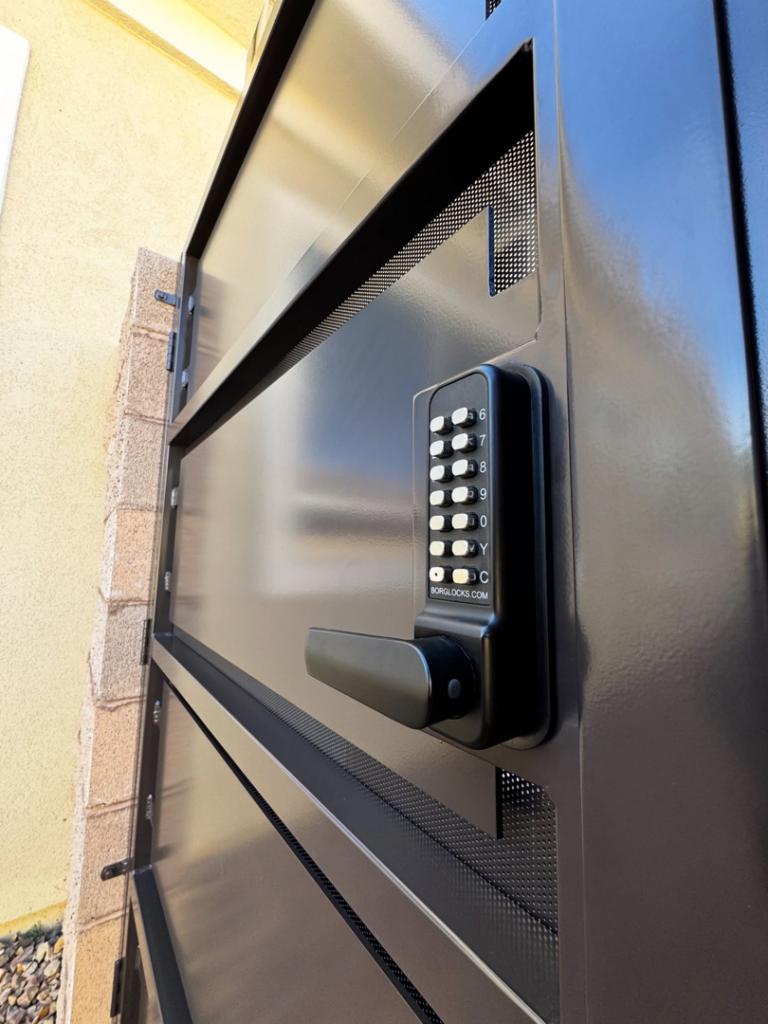 A modern black security gate with a keypad lock installed by Custom Customs Inc. in Henderson, NV