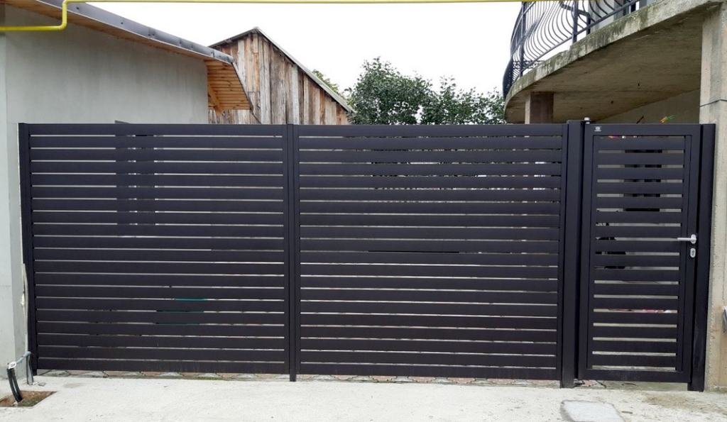 A modern dark gray slatted fence and gate installation completed by New Euro Fences CA in Sacramento, CA.