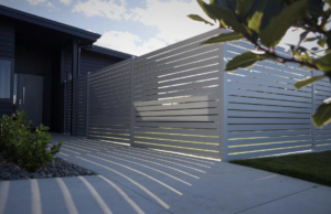 A long, modern light grey slatted privacy fence installed along a residential property by Bespoke Gate Fence & Deck in Christchurch, NZ.
