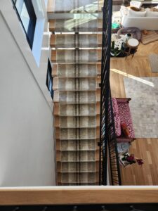 A modern staircase featuring a stylish carpet runner installed by Carpet One Floor & Home Denver in Denver, CO.