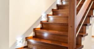 Modern step lighting installed on a wooden staircase, a service provided by Airhart Electric, Inc. in Coventry, RI