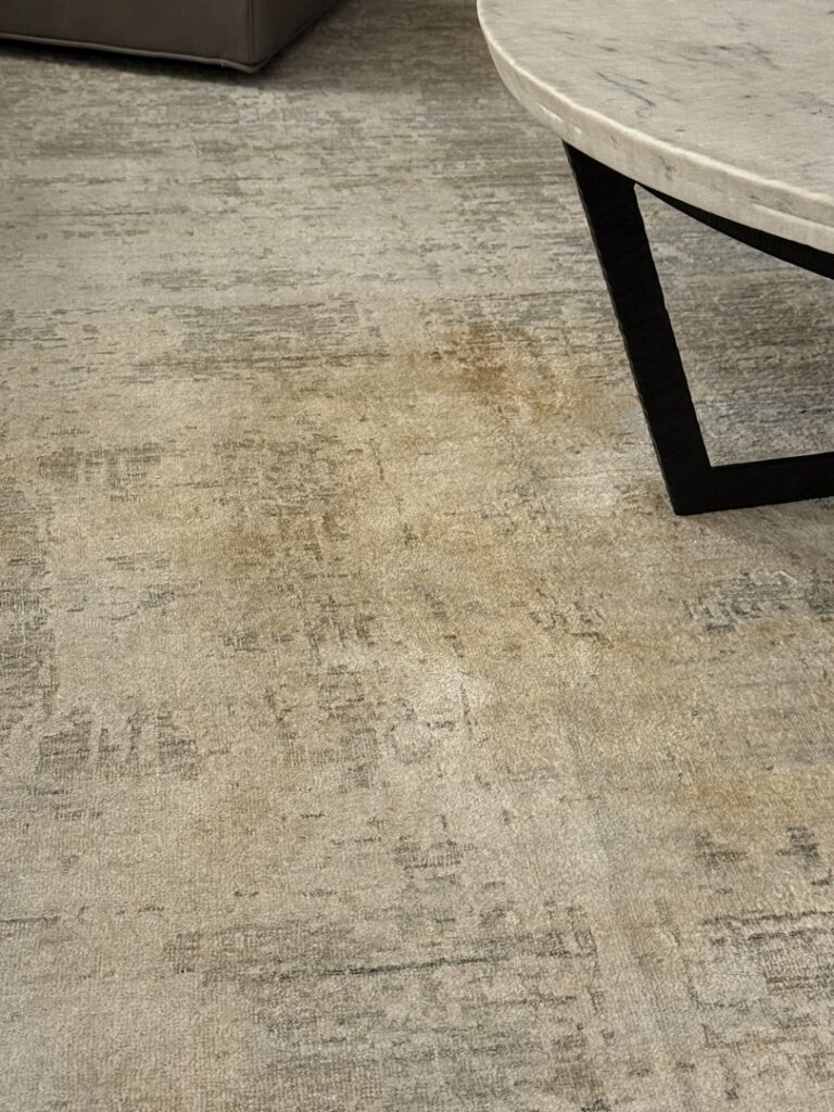 A modern, textured area rug on a hard floor, representing the variety of rugs cleaned by Carpet & Rug Cleaning in Mount Pleasant, SC.