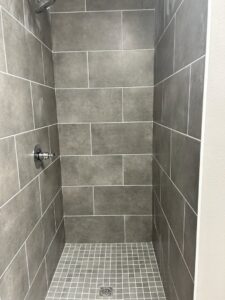A modern tiled shower stall, showcasing tile installation by Carpet World Baton Rouge, LA.
