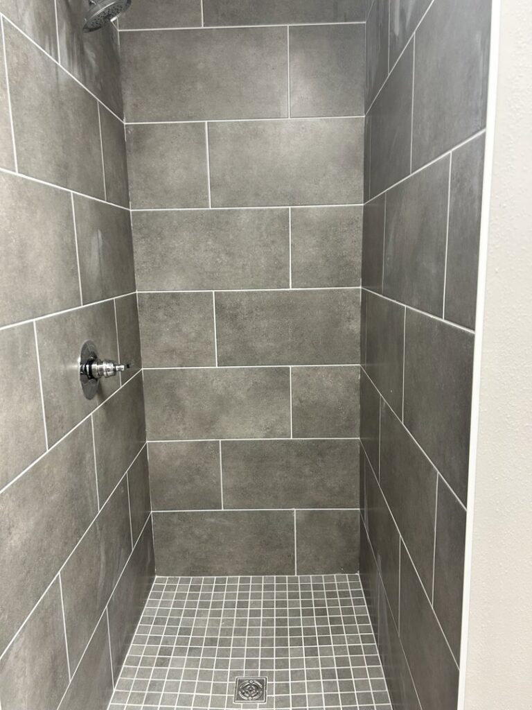 A modern tiled shower stall, showcasing tile installation by Carpet World Baton Rouge, LA.