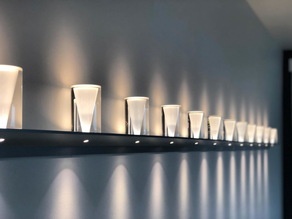 A row of modern wall-mounted lights professionally installed by Obot Electric in Bellevue, WA