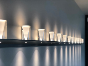 A row of modern wall-mounted lights professionally installed by Obot Electric in Bellevue, WA