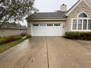 A modern white garage door with top panel windows installed by Geiszler Garage Door in Milwaukee, WI.