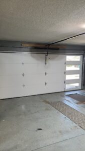 Interior view of a modern white garage door with windows installed by Garage Door Specialists Of Oklahoma Inc. in Oklahoma City, OK