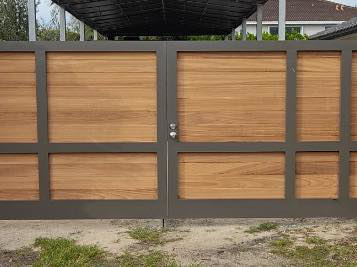 A modern wood and metal gate installed by HD Multi Service USA INC, showcasing quality craftsmanship in Miami, FL.