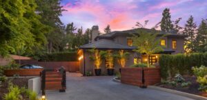 Modern wood driveway gates integrated with landscaping at a residential property by Ozark Fence in Lakewood, CO.