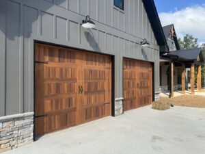 Modern wood grain garage doors installed on a new home by Platinum Garage Door Services in Helena, AL