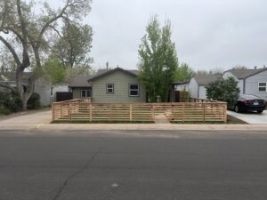 A modern wooden horizontal fence enclosing a front yard, installed by R&S Fencing & Design LLC in Denver, CO.