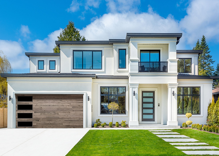 A modern home featuring a stylish wood-look garage door installed by Precision Garage Door Service in Lafayette, LA.