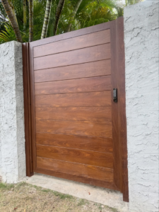 A modern wood-look gate with a keypad entry system installed by A&D Services in Kapolei, HI.