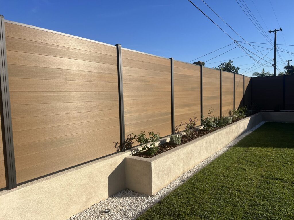 A long modern wood-look horizontal privacy fence installed by No Limit Fence Company in Huntington Beach, CA.
