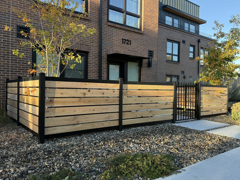 An angled view of a modern wood and metal privacy fence installed by ZBros Fencing LLC in Boise, ID.
