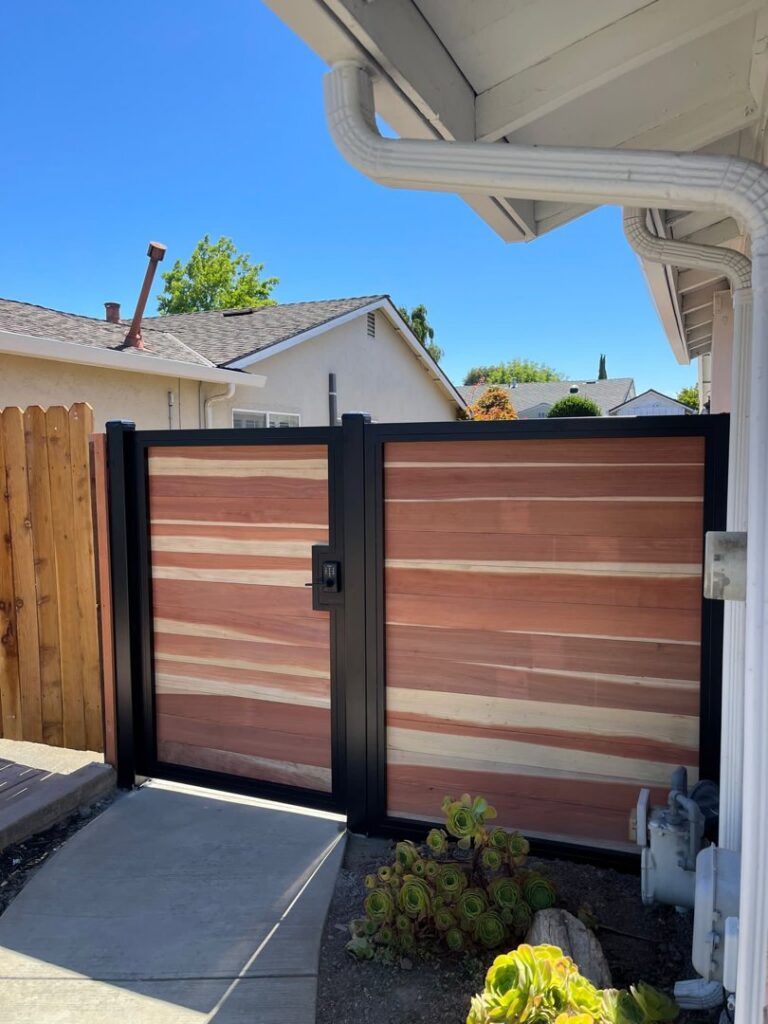 A modern wood and black metal privacy gate installed by Jaz Builders Inc in Santa Clara, CA.