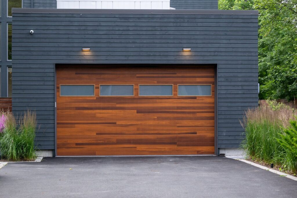 A modern wooden-look garage door with horizontal windows, installed by Max Garage Door in Minneapolis, MN.