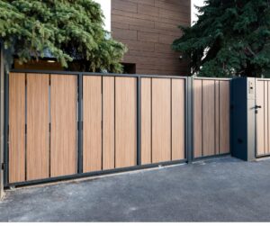 A modern wooden and metal sliding driveway gate, installed by Coastline Gate Repair in Los Angeles, CA.
