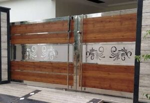 A modern wooden and stainless steel driveway gate with decorative cutouts, installed by Coastline Gate Repair in Los Angeles, CA.