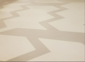A modern zigzag pattern carpet installation, demonstrating unique design work by Flooring Authority, Inc. in Amsterdam, NY.