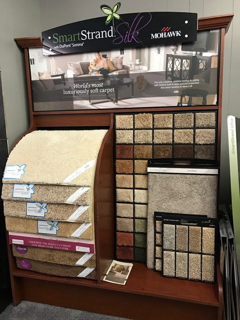 A display featuring Mohawk SmartStrand Silk carpet samples in the showroom of BK The Floor Store of Nebraska in Columbus, NE.