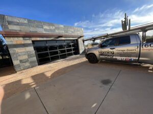 A Morning Star Garage Doors service truck parked at a job site next to a modern garage door in Phoenix, AZ.