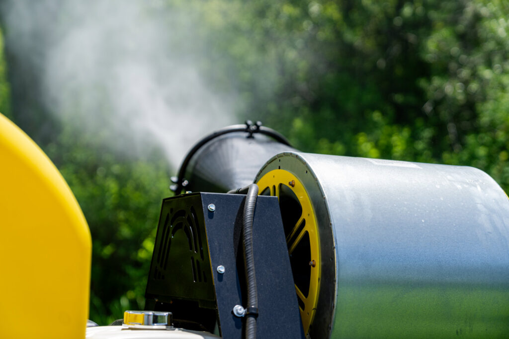 A mosquito control sprayer from Fog'em Mosquito Control releasing a fine mist to treat an outdoor area in Bismarck, ND.