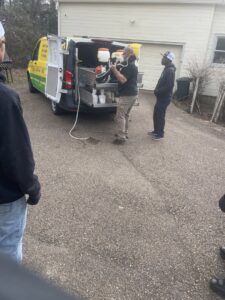A Mosquito Joe of East Mississippi technician preparing pest control equipment from the back of a service van in Meridian, MS.