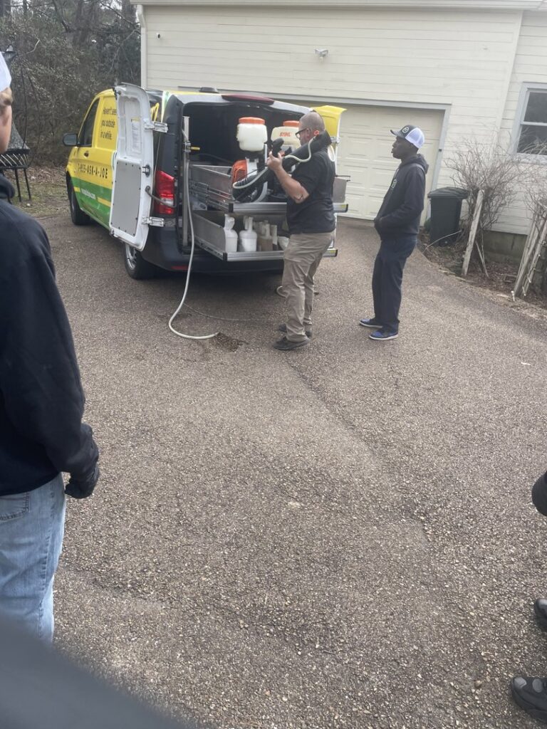 A Mosquito Joe of East Mississippi technician preparing pest control equipment from the back of a service van in Meridian, MS.