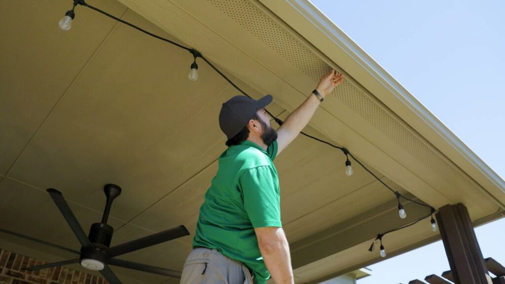 A Mosquito Joe technician treating the eaves of a patio for mosquito and pest control in Newark, DE.