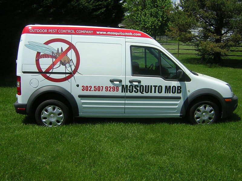 A white Mosquito Mob service van with branding, ready for pest control jobs in Wilmington, DE.