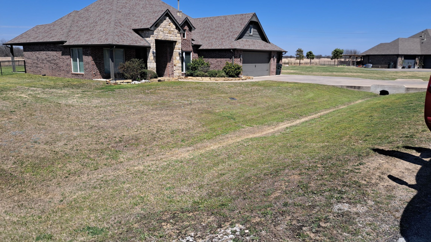 A freshly mowed residential lawn with clear stripes by R & W Lawn care service LLC in Tulsa, OK.