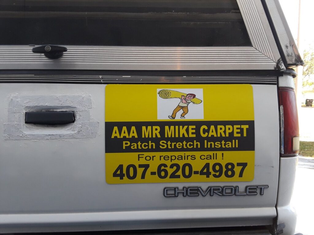 A close-up of the Mr. Carpet Cleaning Orlando, FL truck magnet, detailing carpet patch, stretch, and install services.