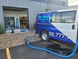 The Mr. Suds Carpet Cleaning LLC van with hoses extended, set up for a job in Coeur d'Alene, ID.