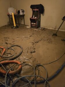 A muddy floor undergoing water extraction and restoration by Big Red Flooring in Omaha, NE