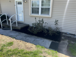 Well-maintained mulched shrub beds at a residential property by All Things Lawncare in Knoxville, TN.