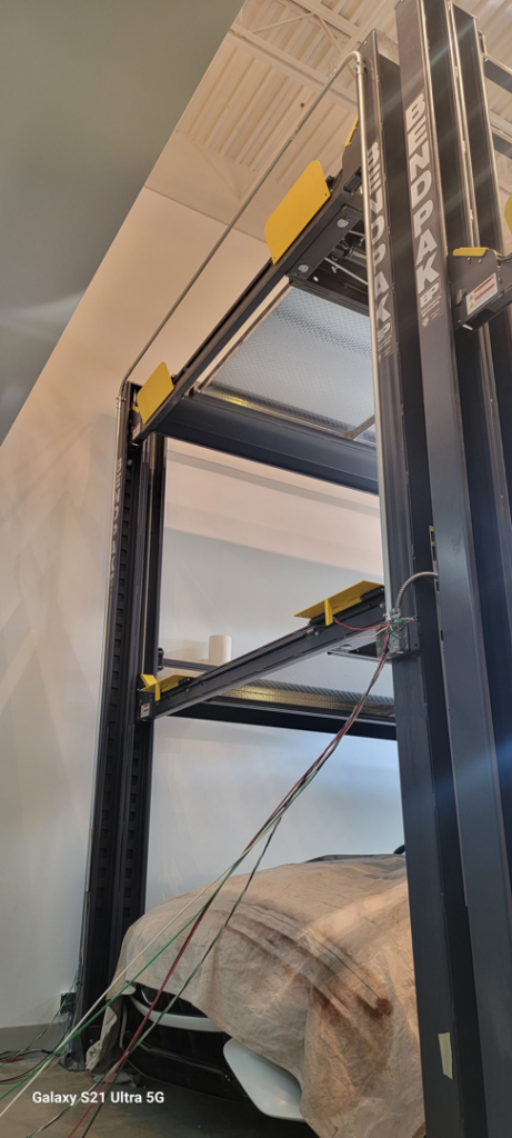 Electrical conduit and wiring installed on a multi-level car lift by Kross Homes & Security in Dallas, TX