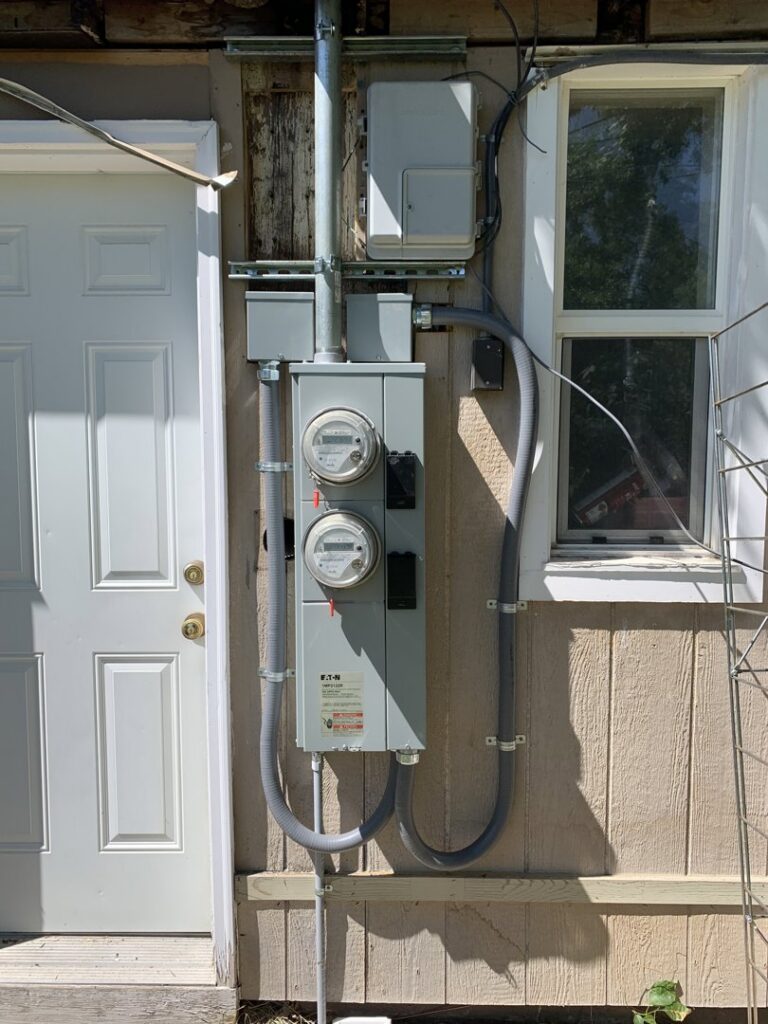 A new multi-meter exterior electrical service installation on a building by Copper Canyon Electric in Farmington, UT.