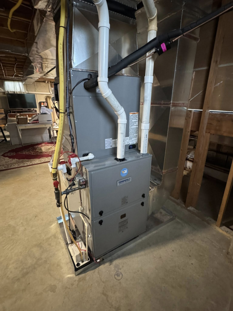 A multi-stage furnace or air handler unit with extensive ductwork and piping installed by Vai Services in Wilmington, DE.
