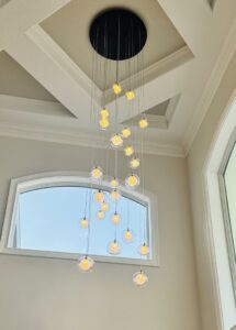 A multi-tier chandelier with many small lights professionally installed by Small Jobs Electric in Tampa, FL.