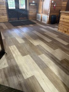 A modern entryway with multi-toned luxury vinyl plank flooring installed by Carpet Direct Brandon Burley in Tulsa, OK.