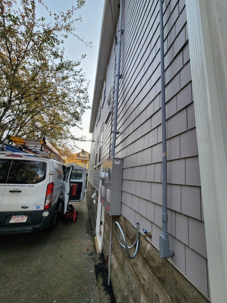 Multi-unit electrical meter and conduit installation on a building by Julio A Lopez Electrician in Lowell, MA.