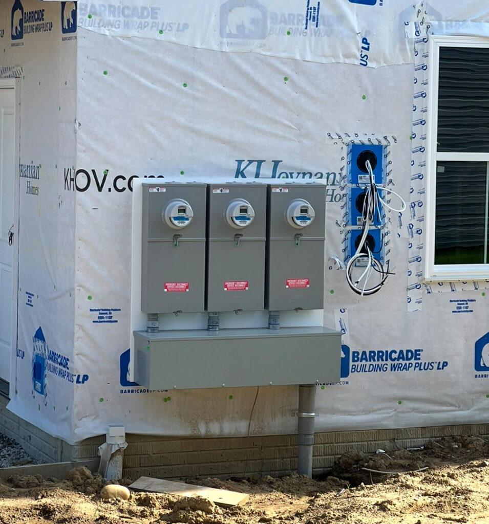 Multiple electrical meter bases and conduit installed on the exterior of a building under construction by Kouris Electric LLC in Canton, OH.