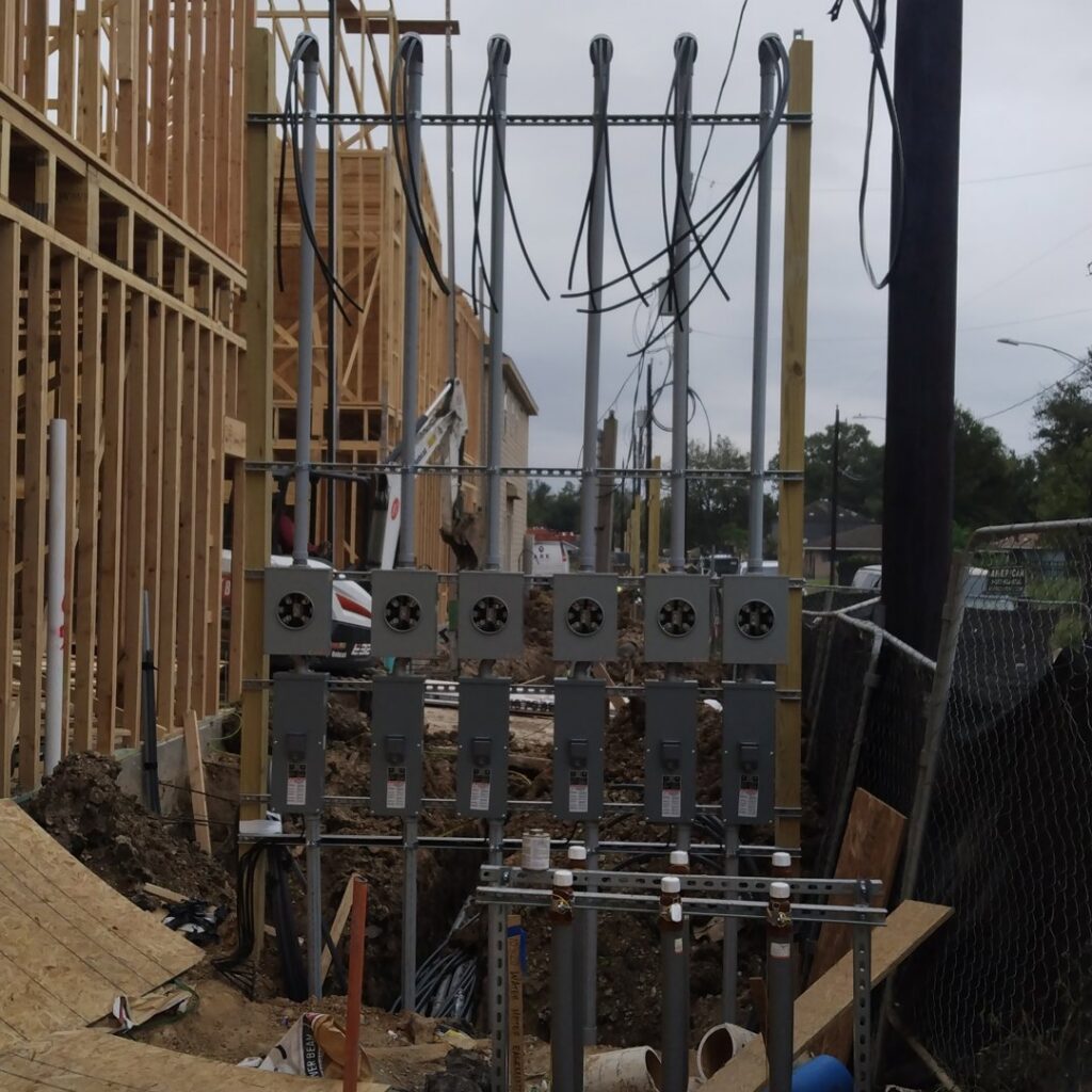 Multi-unit electrical panel and meter base installation at a construction site by Ark Electrical Service in Tomball, TX