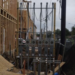 Multi-unit electrical panel and meter base installation at a construction site by Ark Electrical Service in Tomball, TX