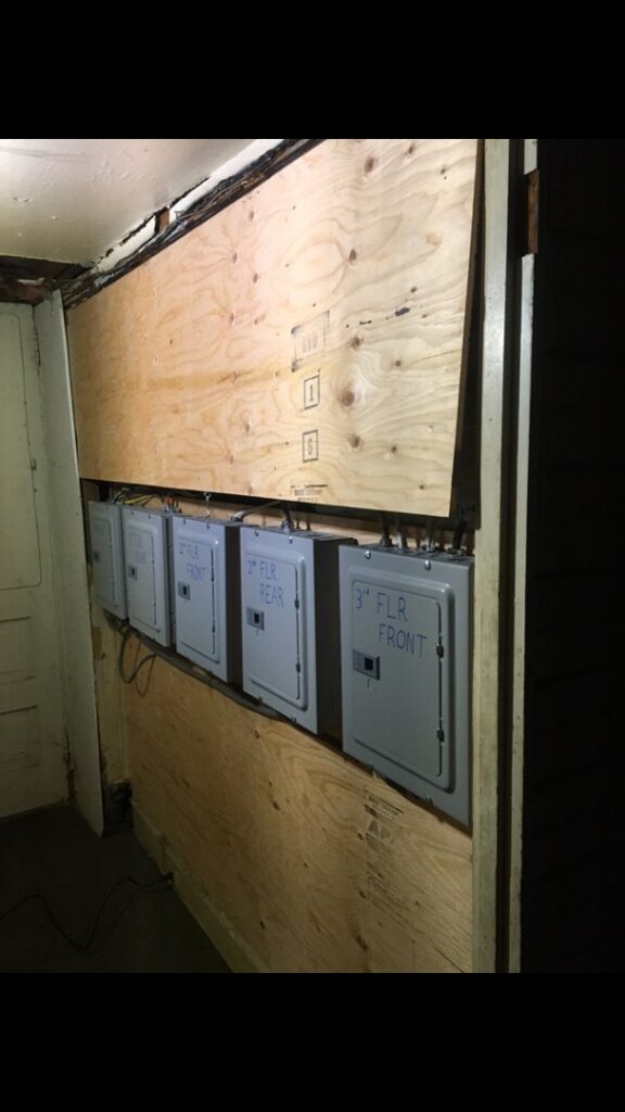 Multi-unit electrical panel installation with labeled boxes by John Fean Electrician Inc. in Philadelphia, PA.