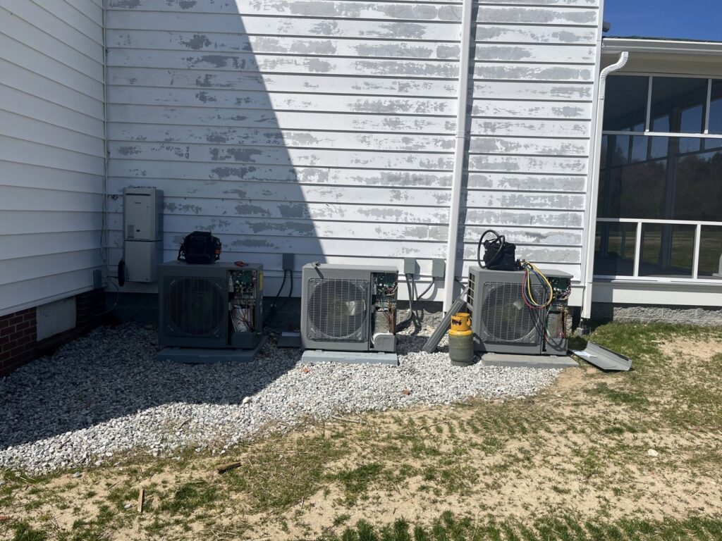 Multiple outdoor air conditioning units being serviced or installed by Climate Mechanical in Dinwiddie, VA.