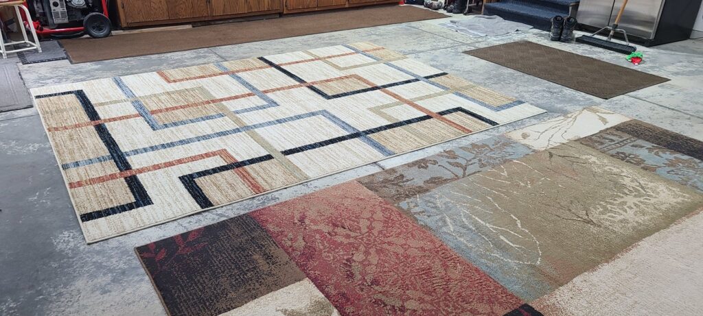 Several patterned area rugs laid out, ready for or after professional cleaning by Norris Carpet Care in Watertown, SD.