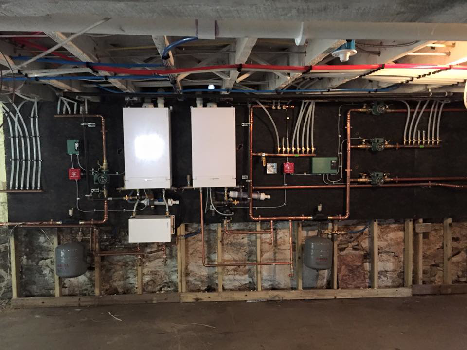 Multiple boilers, water heaters, and copper piping installed by Ausoli Grace Plumbing & Hvac in South Portland, ME.